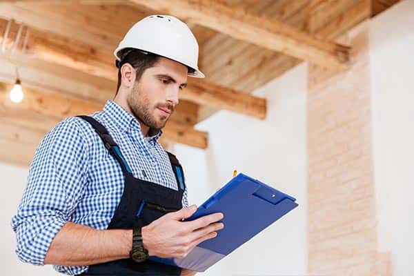 Spray foam insulation estimator with a clipboard.