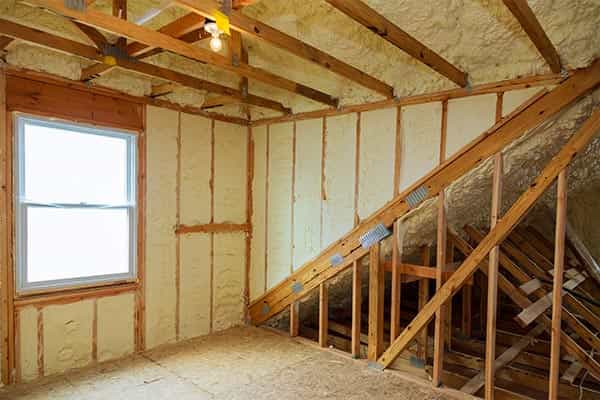 Spray foam insulation applied to interior construction, and exposed beams.